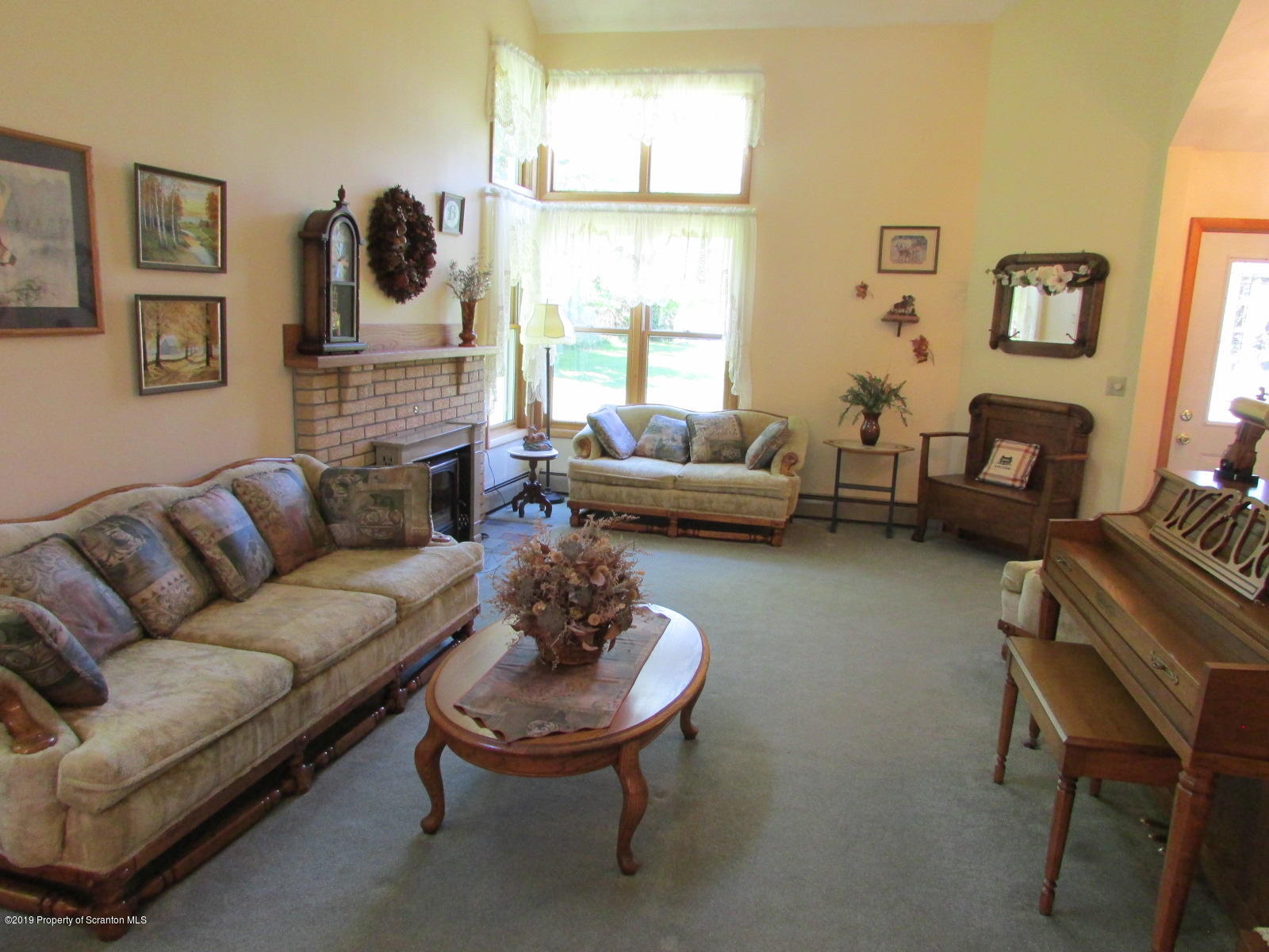 1315 Old County Road Montrose, PA 18801 - Photo 25 of 74 a living room with furniture a fireplace and a large window