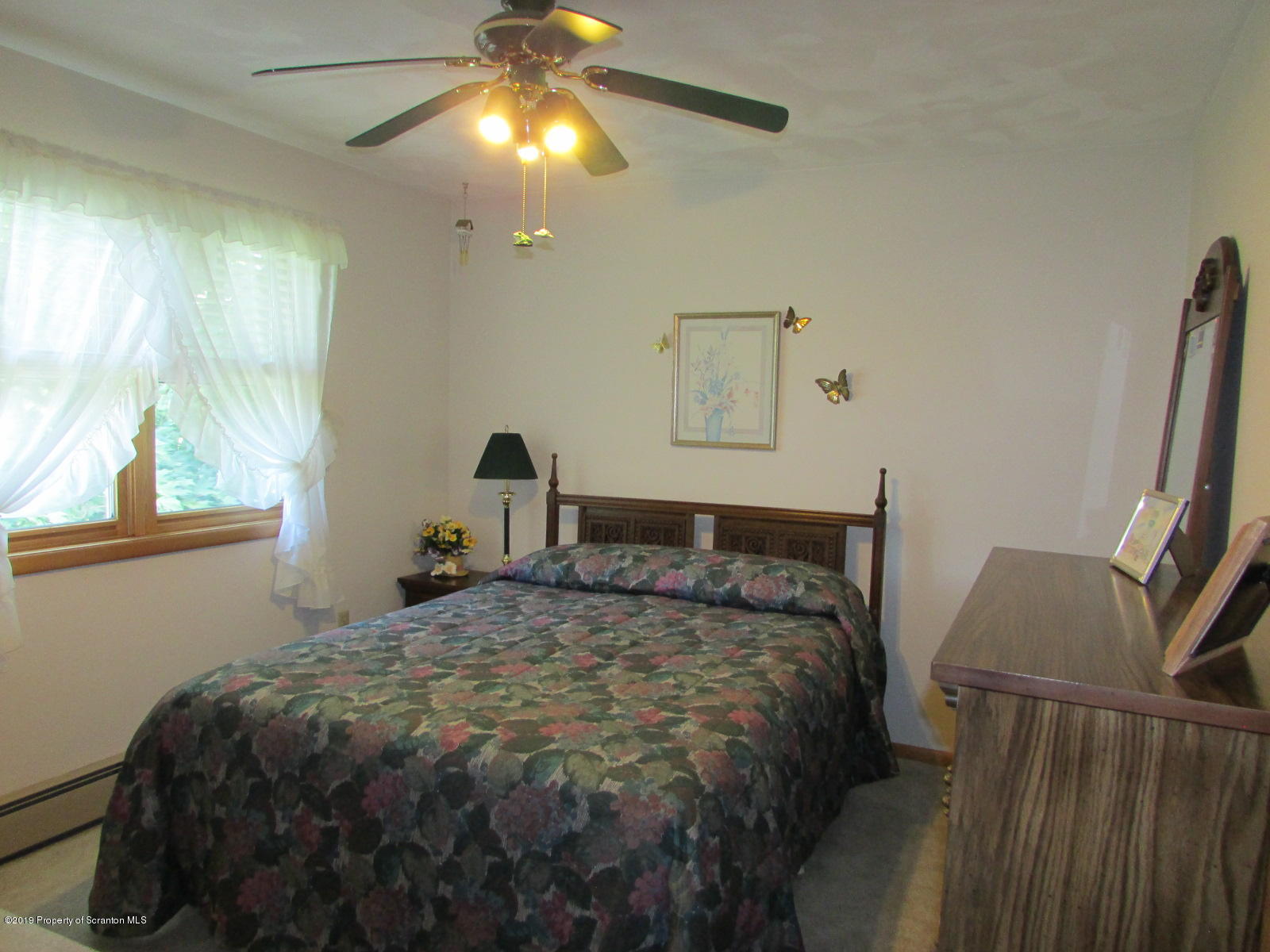 1315 Old County Road Montrose, PA 18801 - Photo 32 of 74 a bedroom with a bed and a chandelier