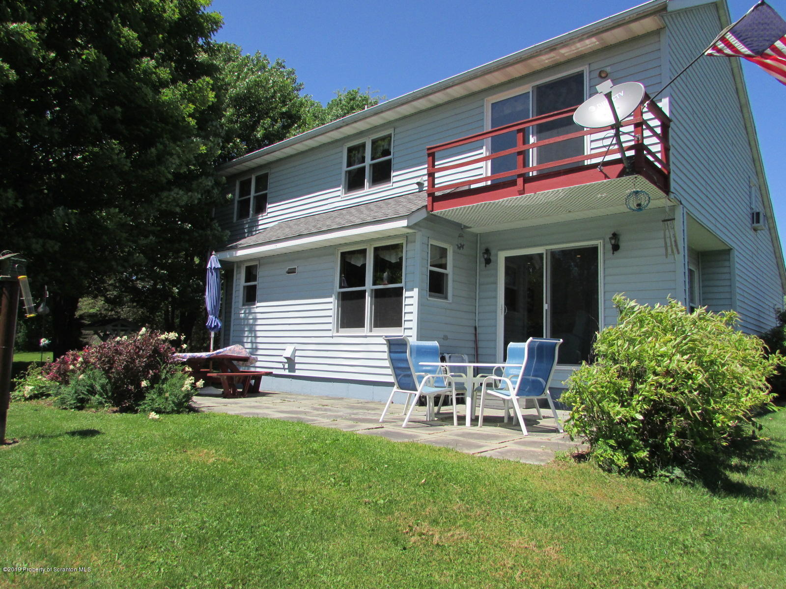 1315 Old County Road Montrose, PA 18801 - Photo 61 of 74 a view of a house with backyard sitting area and garden