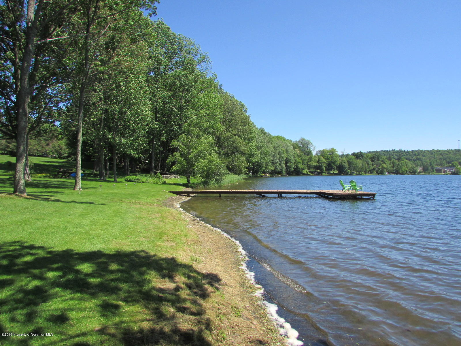1315 Old County Road Montrose, PA 18801 - Photo 7 of 74 a view of a lake with a yard and large trees