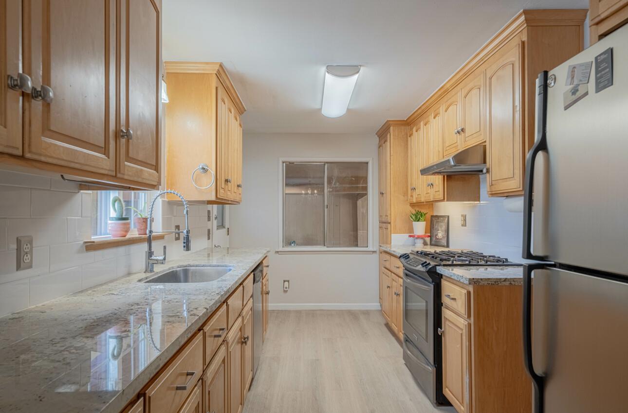 454 Paradise Road Salinas, CA 93907 - Photo 11 of 31 a kitchen with stainless steel appliances granite countertop a sink stove and refrigerator