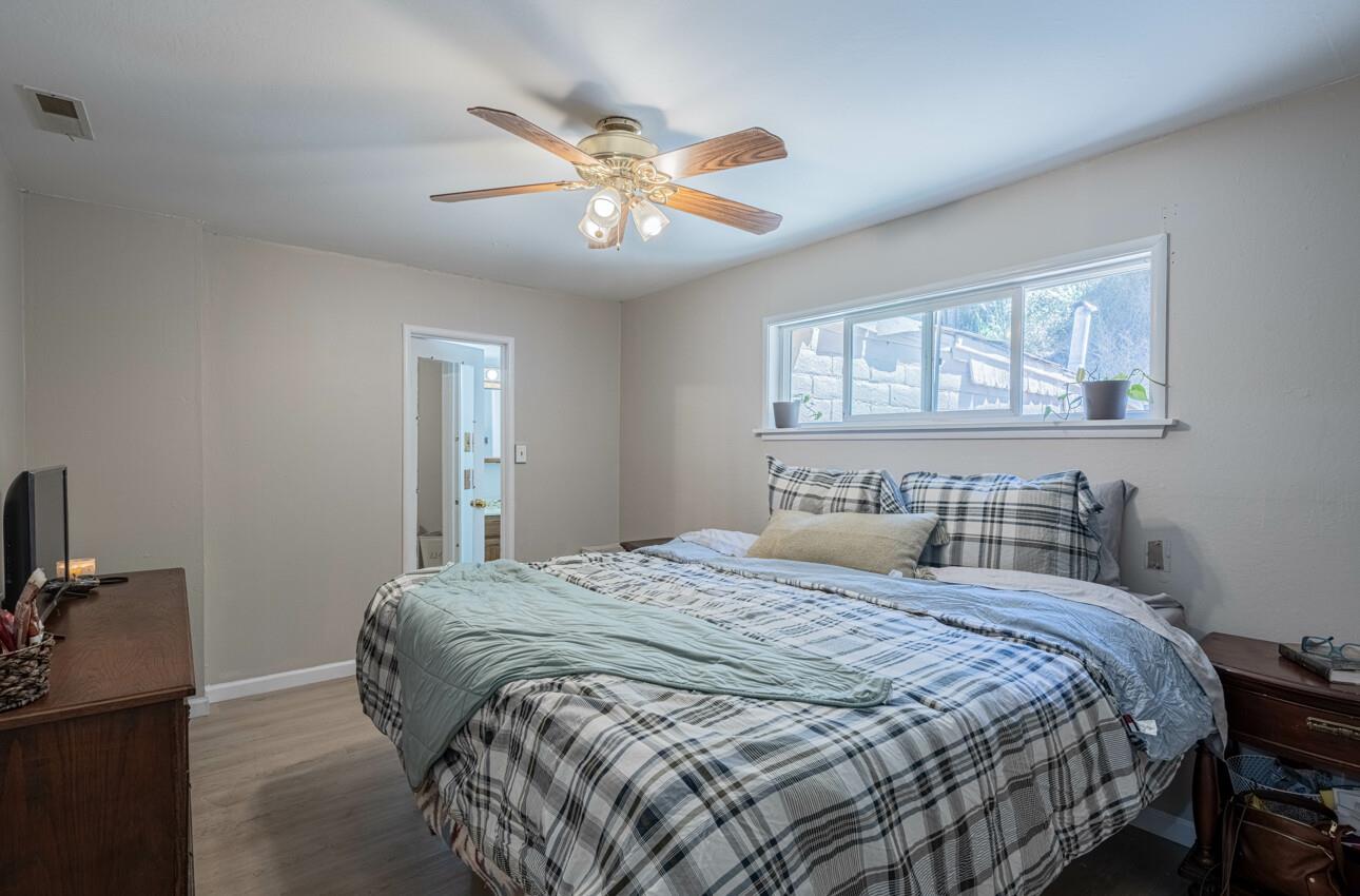 454 Paradise Road Salinas, CA 93907 - Photo 14 of 31 a bedroom with a large bed and a chandelier