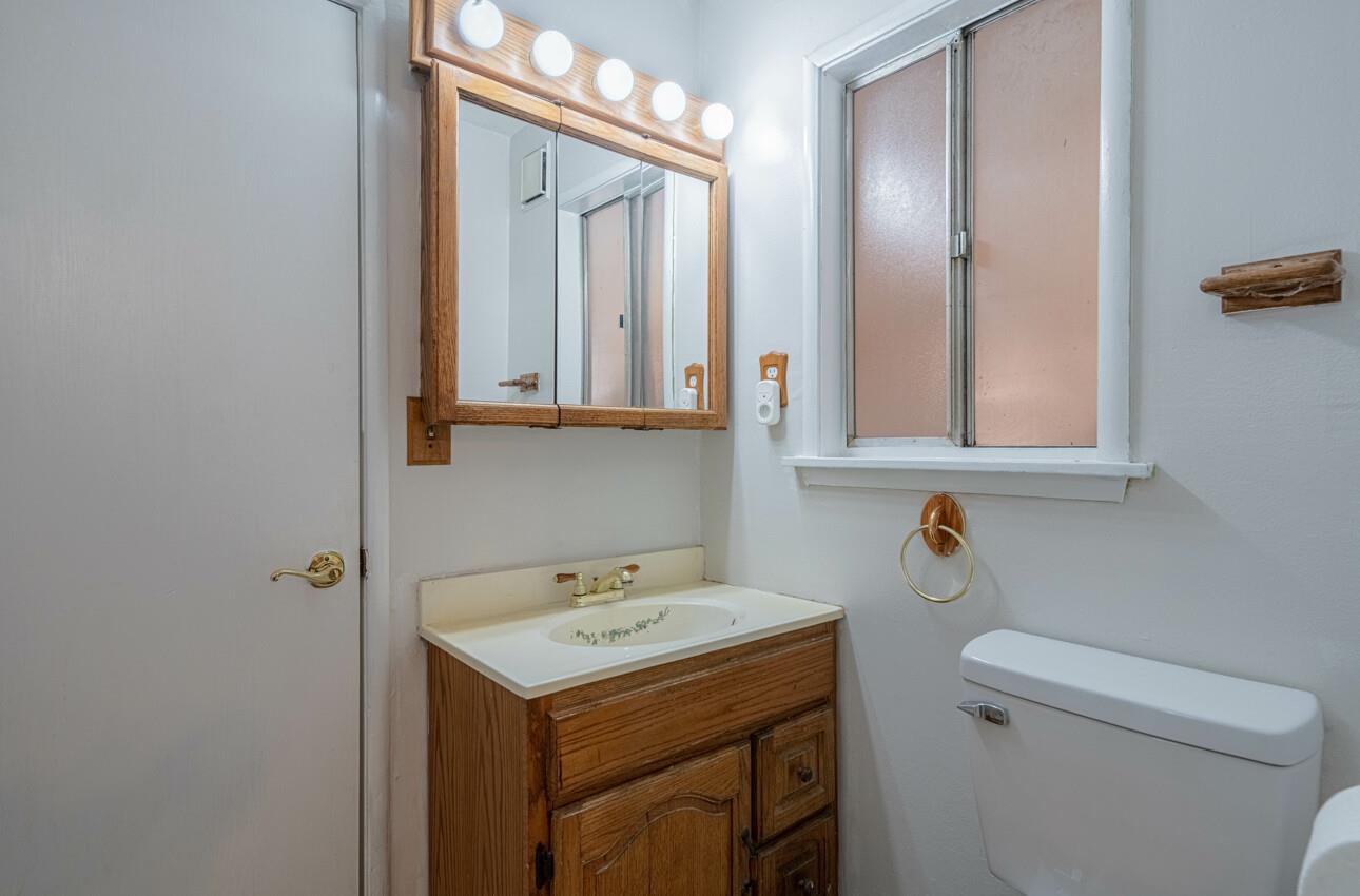 454 Paradise Road Salinas, CA 93907 - Photo 16 of 31 a bathroom with a sink a toilet and mirror