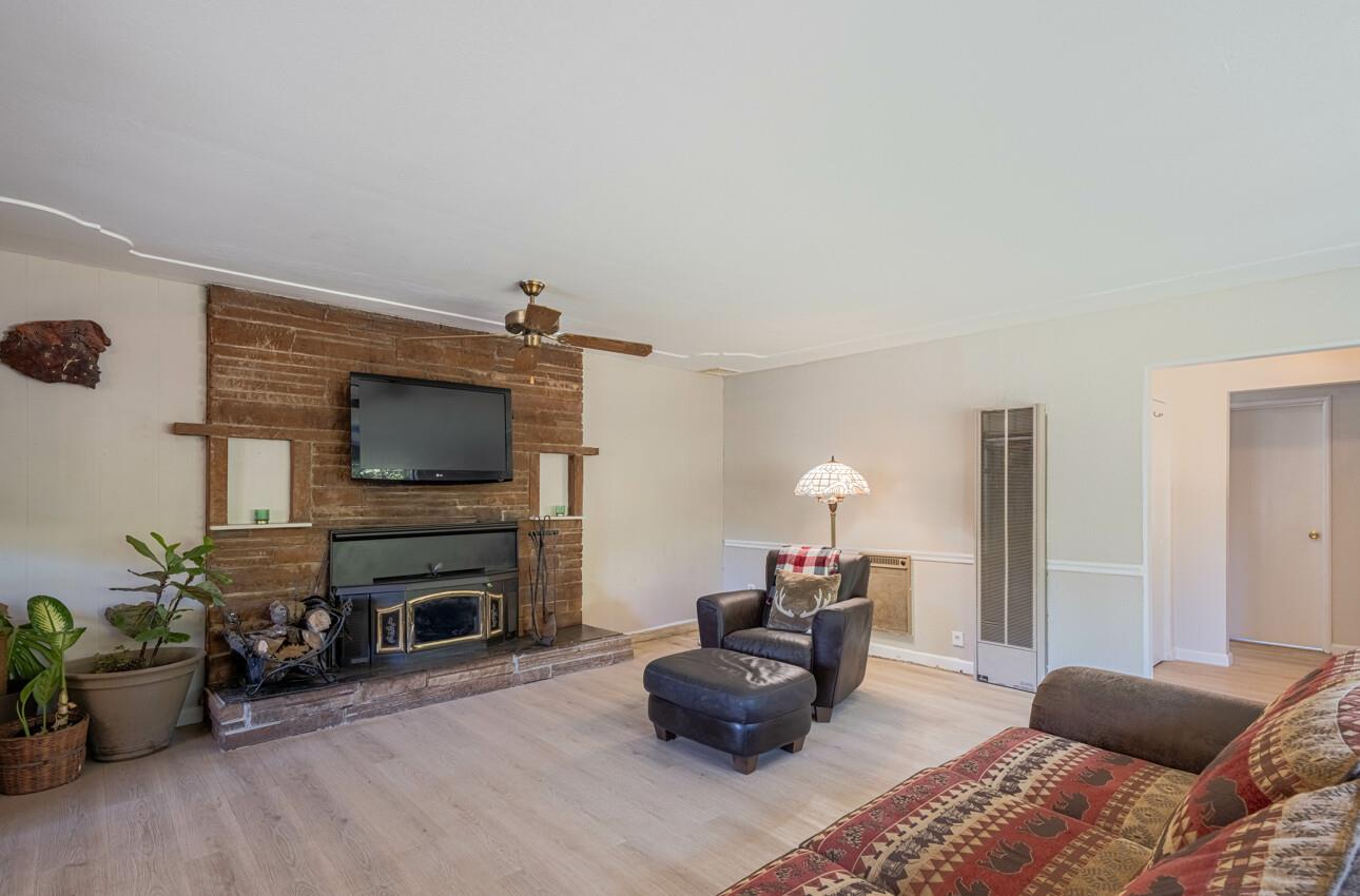 454 Paradise Road Salinas, CA 93907 - Photo 6 of 31 a living room with furniture a flat screen tv and a fireplace