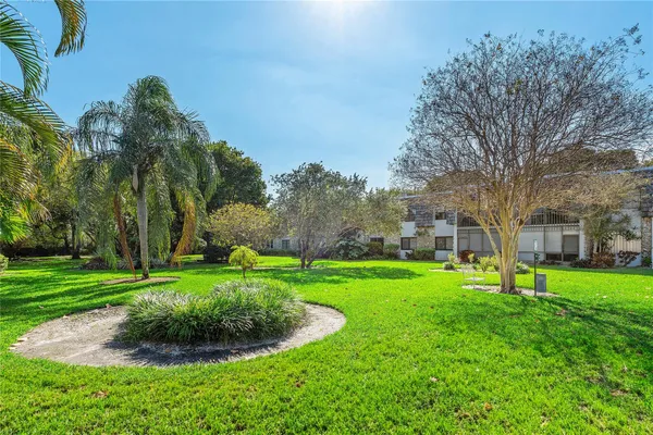 a garden with trees in front of it