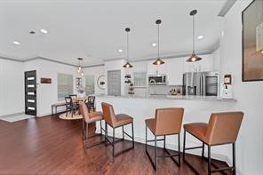 907 Frio Street Houston, TX 77012 - Photo 11 of 23 a dining room filled chandelier and wooden floor
