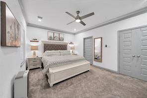 907 Frio Street Houston, TX 77012 - Photo 17 of 23 a bedroom with a large bed and ceiling fan