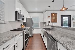 907 Frio Street Houston, TX 77012 - Photo 3 of 23 a large kitchen with granite countertop a sink and a stove