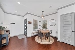 907 Frio Street Houston, TX 77012 - Photo 5 of 23 a view of a dining room with furniture a chandelier and wooden floor