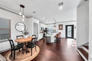 907 Frio Street Houston, TX 77012 - Photo 7 of 23 a view of a dining room with furniture and wooden floor