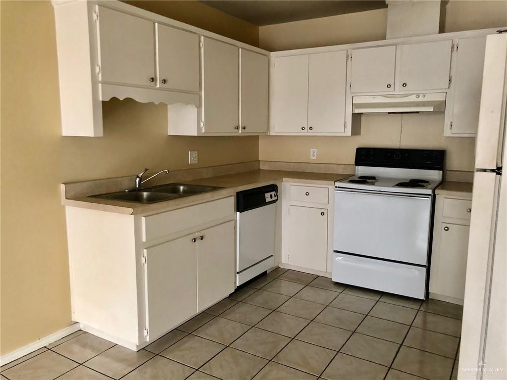2508 East U.S. Business 83, Unit 27 Mission, TX 78572 - Photo 5 of 14 a kitchen with cabinets appliances and a sink