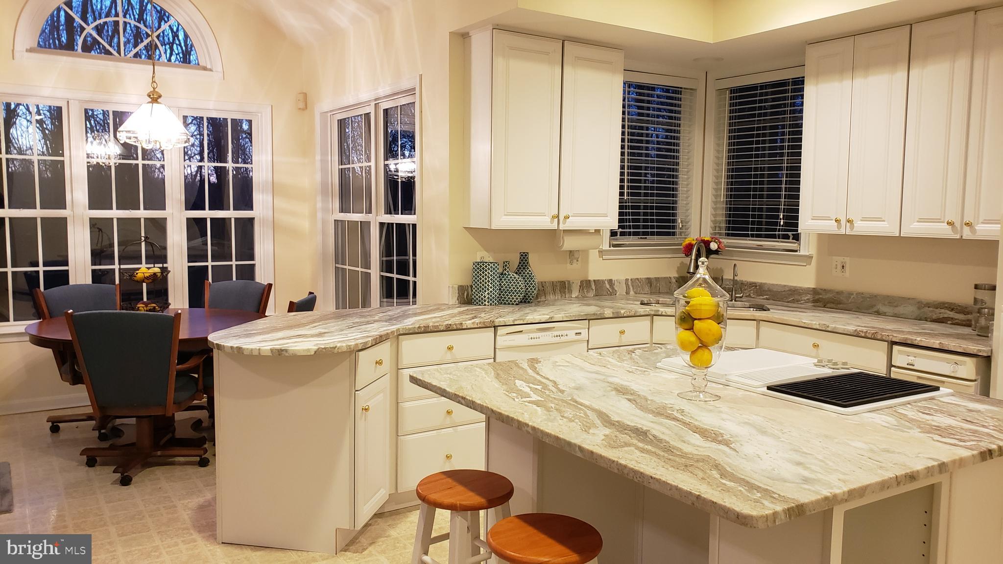 8637 Willow Run Road Baltimore, MD 21244 - Photo 20 of 56 a kitchen with a sink a stove and a refrigerator