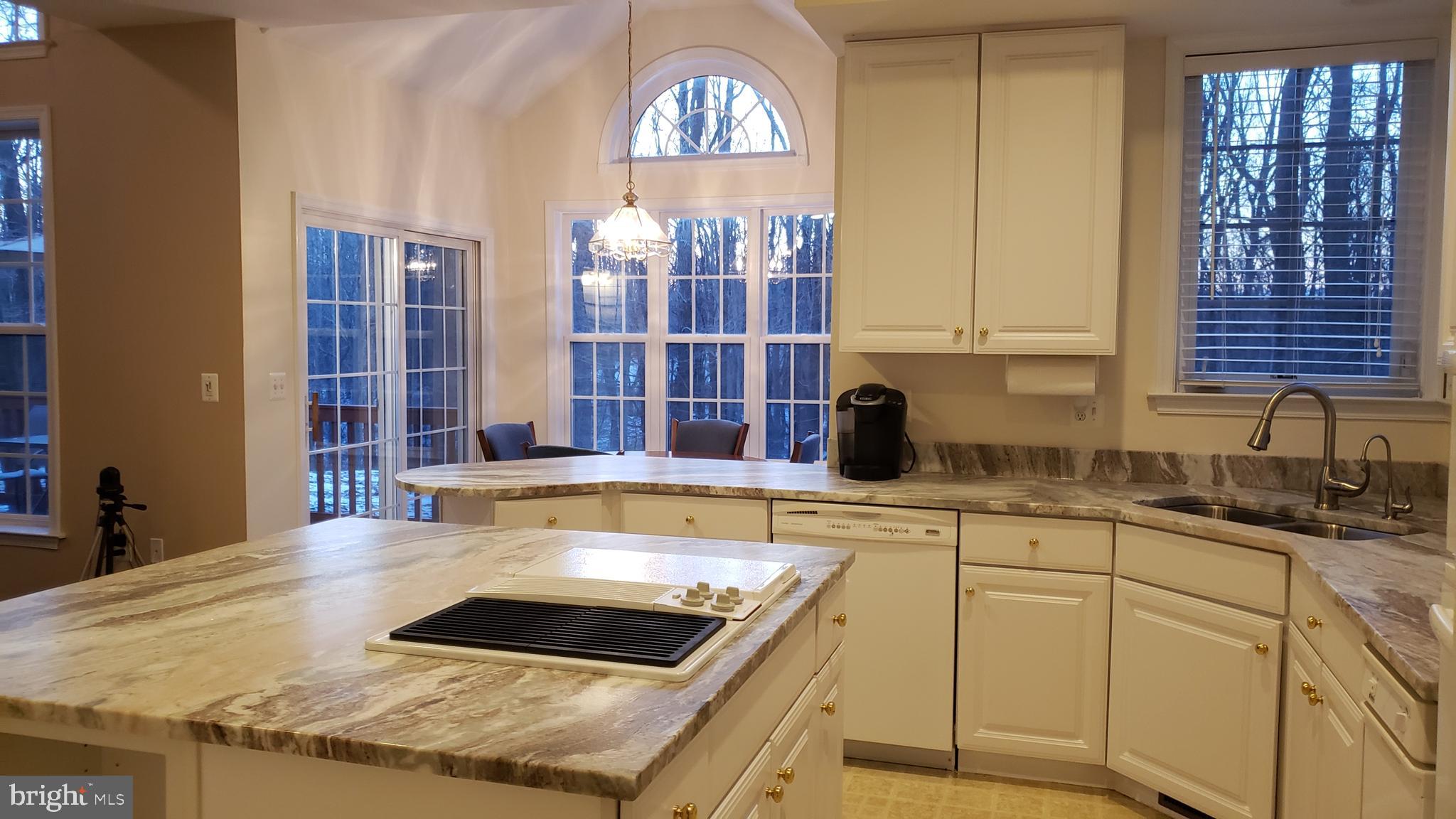 8637 Willow Run Road Baltimore, MD 21244 - Photo 22 of 56 a kitchen with stainless steel appliances granite countertop a stove a sink and a microwave