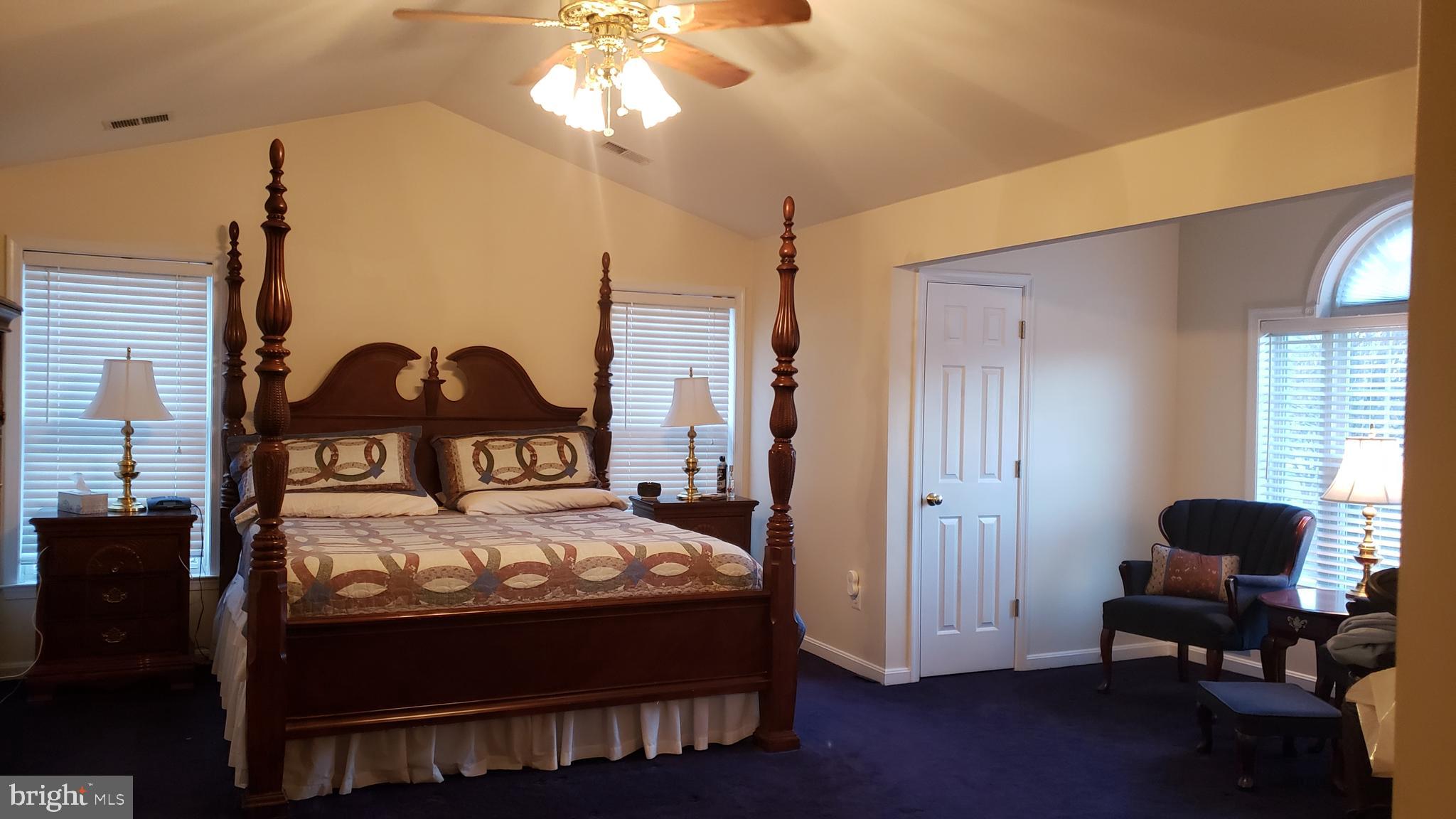 8637 Willow Run Road Baltimore, MD 21244 - Photo 31 of 56 a bedroom with a bed and a chandelier