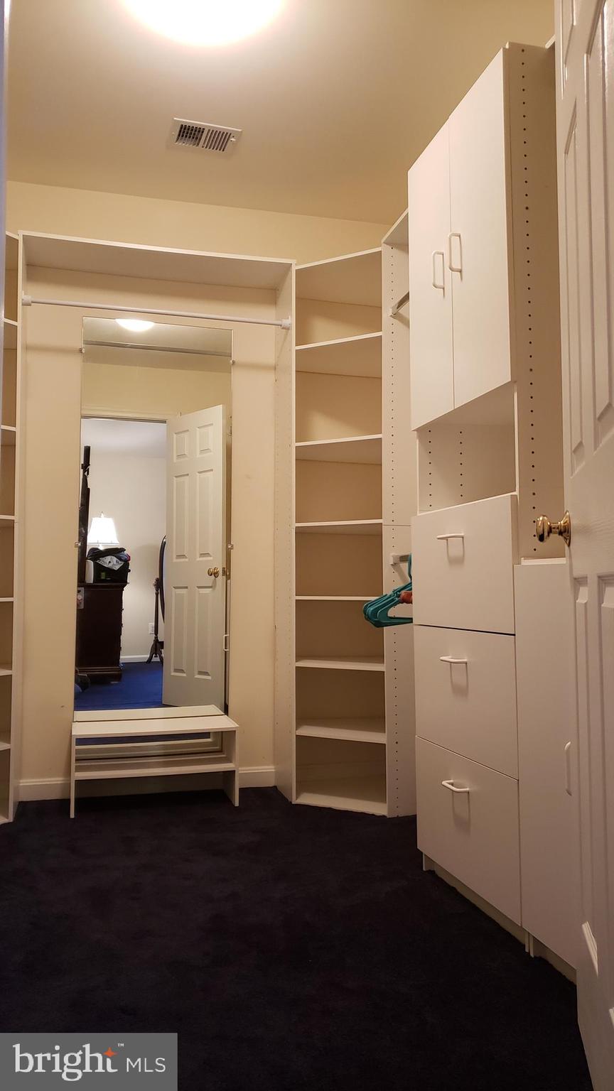 8637 Willow Run Road Baltimore, MD 21244 - Photo 33 of 56 a view of walk in closet with empty racks