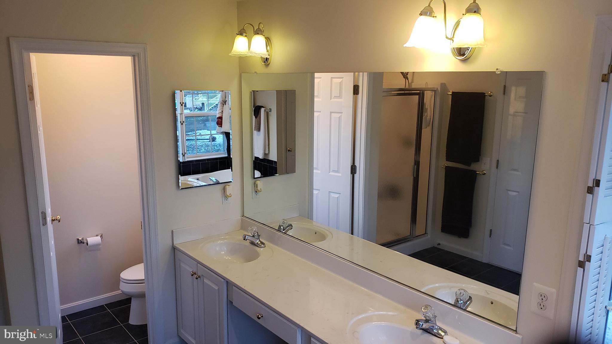 8637 Willow Run Road Baltimore, MD 21244 - Photo 38 of 56 a bathroom with a sink toilet and shower