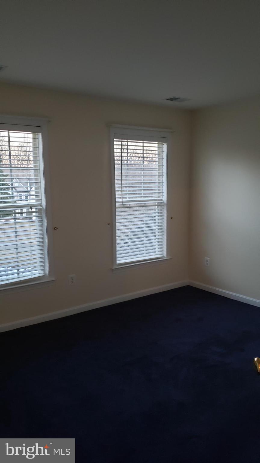 8637 Willow Run Road Baltimore, MD 21244 - Photo 43 of 56 an empty room with wooden floor and windows