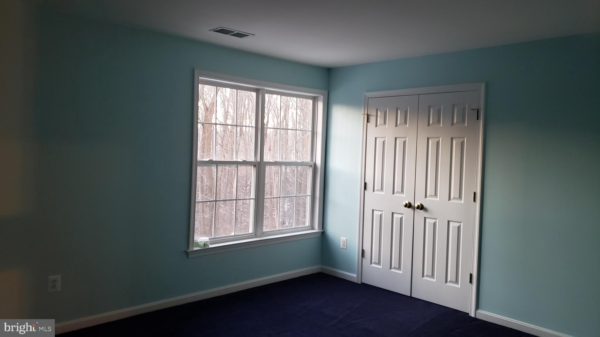 8637 Willow Run Road Baltimore, MD 21244 - Photo 44 of 56 an empty room with wooden floor and windows