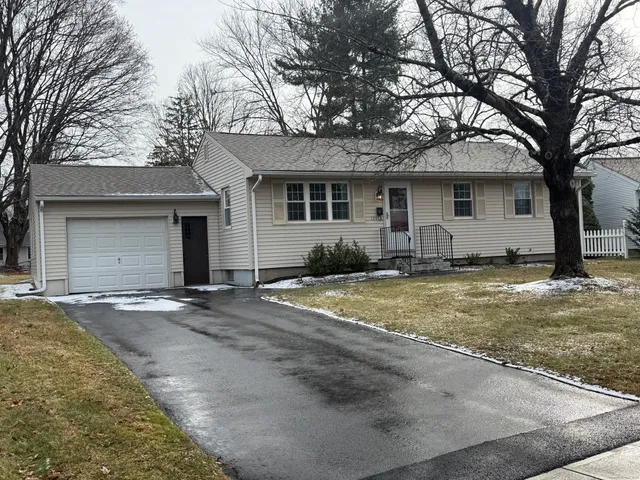 a view of a house with snow on the road