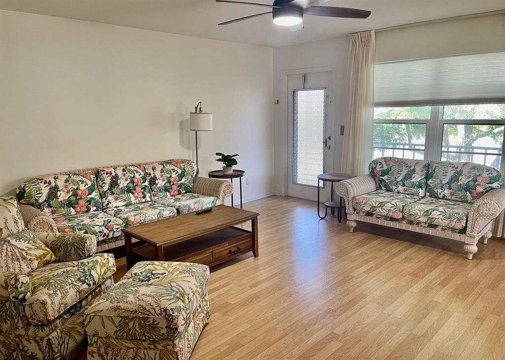 35 Pine Arbor Lane, Unit 202 Vero Beach, FL 32962 - Photo 3 of 16 a living room with furniture and wooden floor