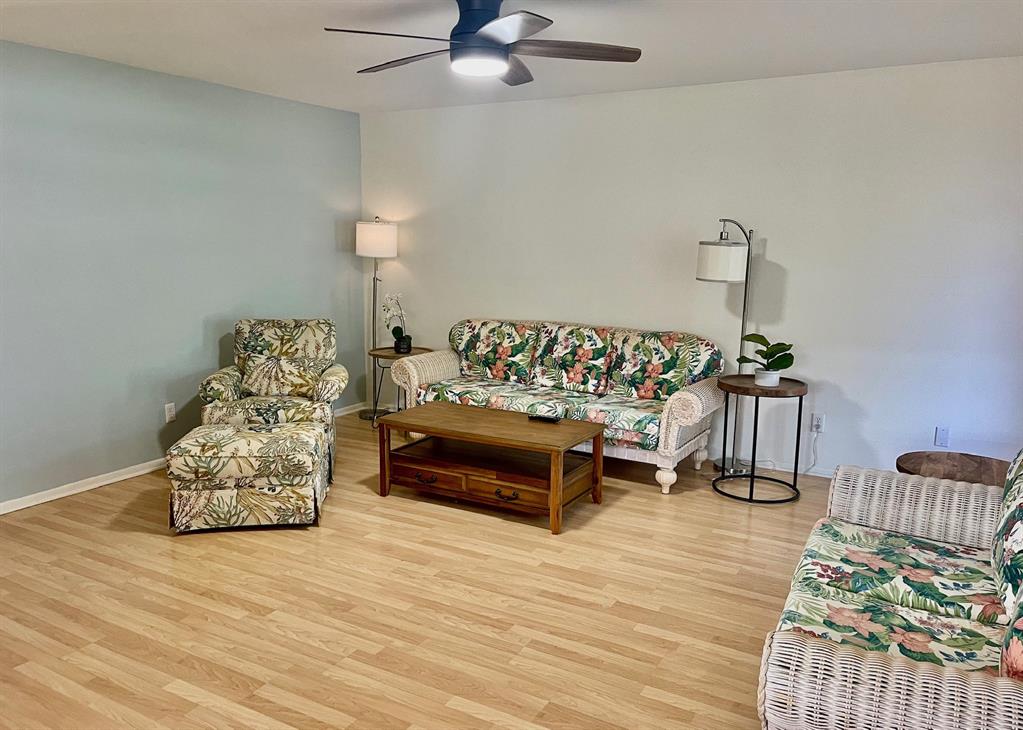 35 Pine Arbor Lane, Unit 202 Vero Beach, FL 32962 - Photo 5 of 16 a bedroom with furniture and a wooden floor