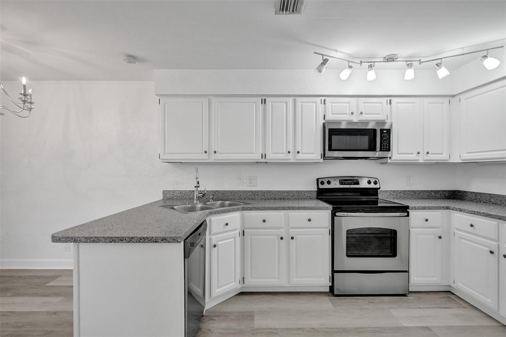 11652 Northwest 19th Drive Coral Springs, FL 33071 - Photo 11 of 52 a kitchen with stainless steel appliances granite countertop a sink a stove a microwave and cabinets