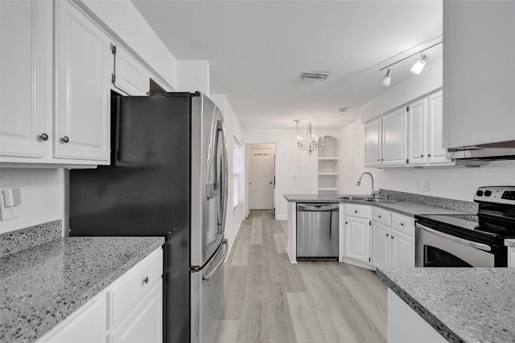 11652 Northwest 19th Drive Coral Springs, FL 33071 - Photo 12 of 52 a kitchen with stainless steel appliances granite countertop a refrigerator and a stove