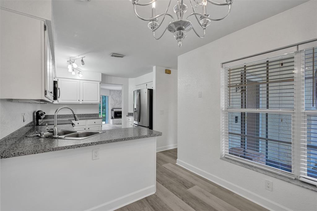 11652 Northwest 19th Drive Coral Springs, FL 33071 - Photo 17 of 52 a kitchen with stainless steel appliances granite countertop a sink a counter space and cabinets