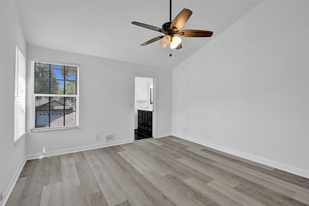 11652 Northwest 19th Drive Coral Springs, FL 33071 - Photo 23 of 52 wooden floor in an empty room with a window