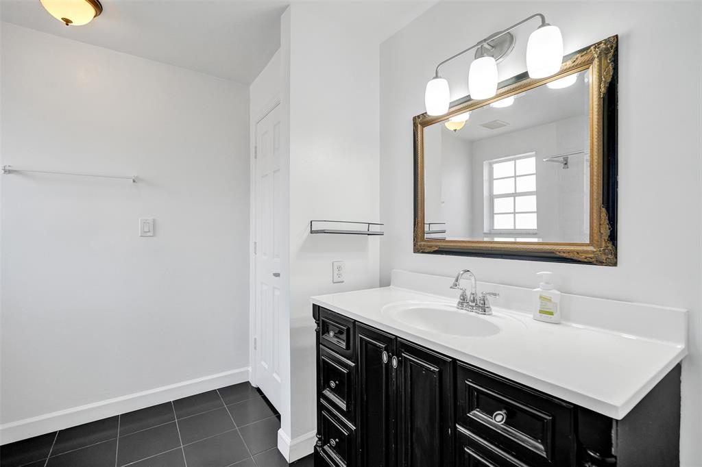 11652 Northwest 19th Drive Coral Springs, FL 33071 - Photo 27 of 52 a bathroom with a sink double vanity and a mirror