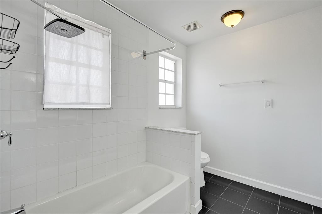 11652 Northwest 19th Drive Coral Springs, FL 33071 - Photo 29 of 52 a bathroom with a bathtub and a window