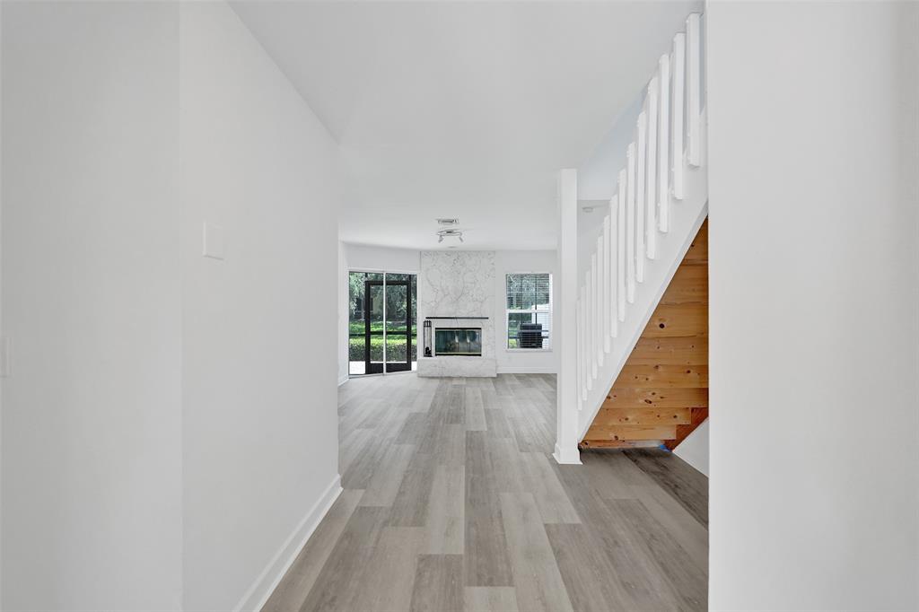 11652 Northwest 19th Drive Coral Springs, FL 33071 - Photo 3 of 52 a view of a hallway with wooden floor and staircase