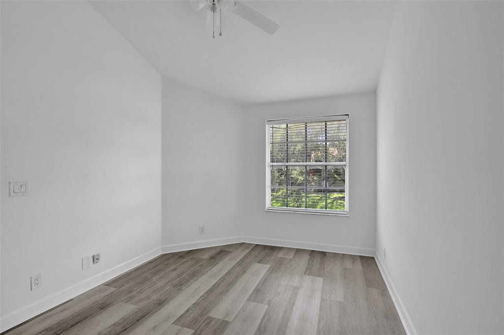 11652 Northwest 19th Drive Coral Springs, FL 33071 - Photo 33 of 52 an empty room with wooden floor and windows