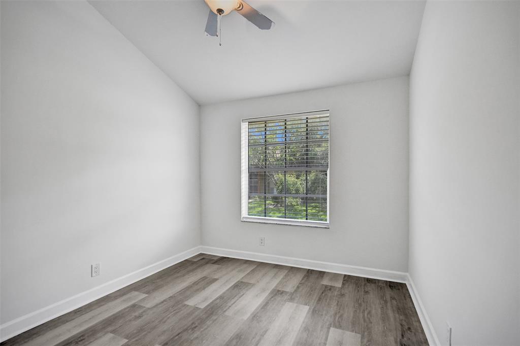 11652 Northwest 19th Drive Coral Springs, FL 33071 - Photo 38 of 52 an empty room with a window and wooden floor