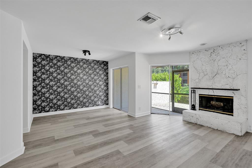 11652 Northwest 19th Drive Coral Springs, FL 33071 - Photo 4 of 52 a view of an empty room with wooden floor fireplace and a window