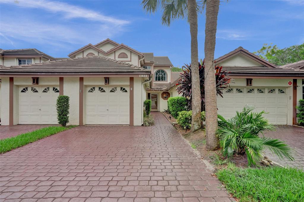 11652 Northwest 19th Drive Coral Springs, FL 33071 - Photo 41 of 52 a front view of a house with a yard and garage
