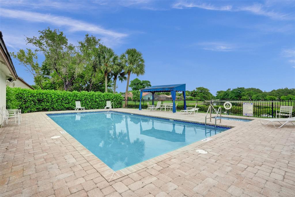 11652 Northwest 19th Drive Coral Springs, FL 33071 - Photo 48 of 52 a view of a swimming pool and a chairs
