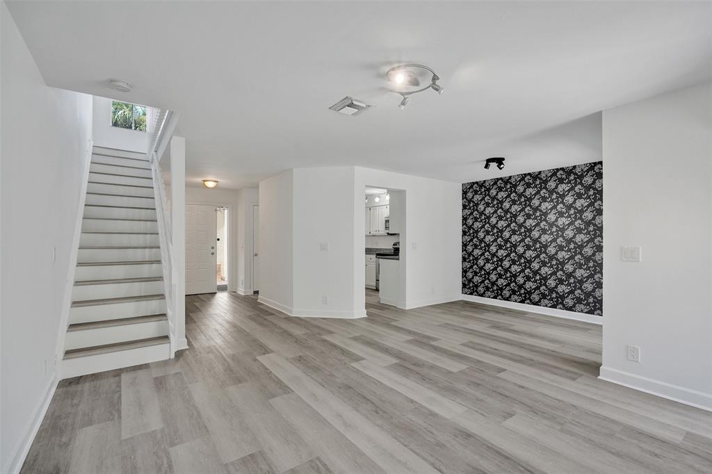 11652 Northwest 19th Drive Coral Springs, FL 33071 - Photo 5 of 52 a view of a hallway with wooden floor and staircase