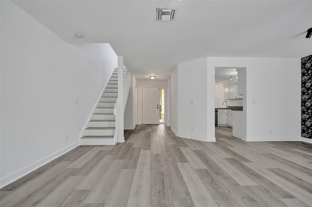 11652 Northwest 19th Drive Coral Springs, FL 33071 - Photo 6 of 52 a view of a hallway with wooden floor and kitchen