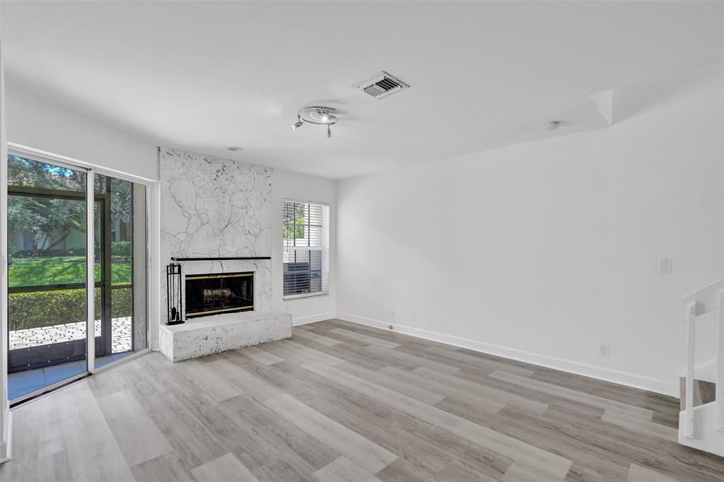 11652 Northwest 19th Drive Coral Springs, FL 33071 - Photo 7 of 52 a view of a livingroom with wooden floor a fireplace and window