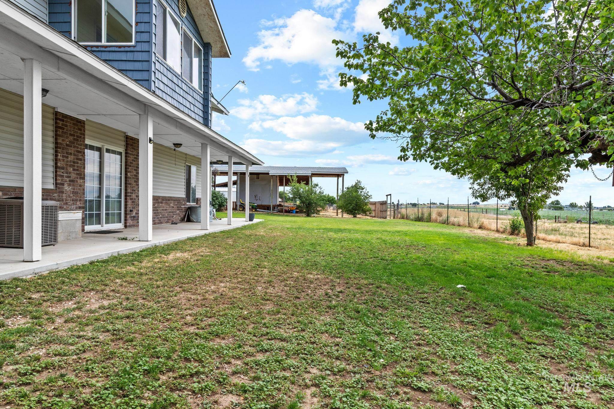 18338 Pride Lane Caldwell, ID 83607 - Photo 41 of 50 Expansive lawn area featuring a mature tree