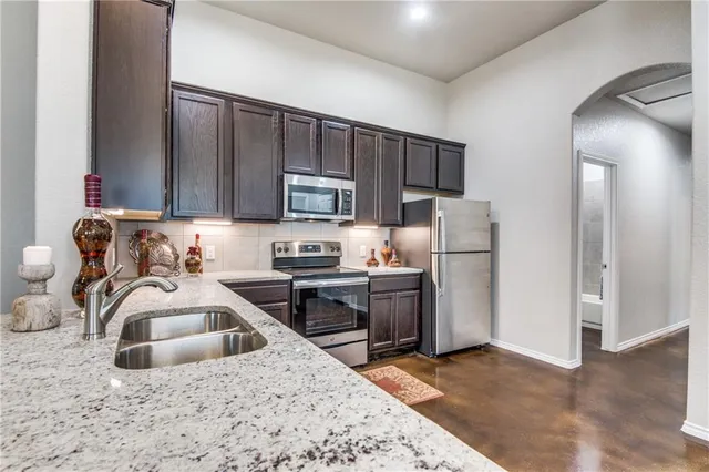 a kitchen with a sink a stove and refrigerator