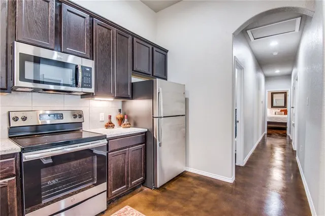 a kitchen with stainless steel appliances a stove microwave and cabinets