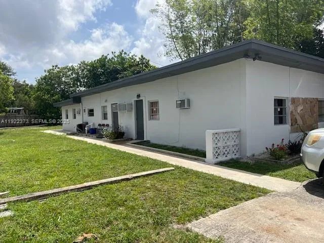 a backyard of a house with table and chairs
