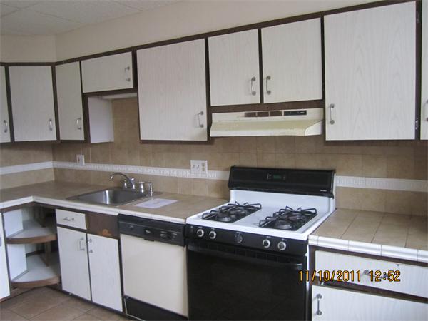 19 Wesley Street Somerville, MA 02145 - Photo 3 of 9 a kitchen with stainless steel appliances granite countertop a sink stove and cabinets