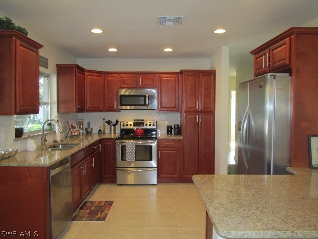4231 Ellis Road Fort Myers, FL 33905 - Photo 4 of 13 a kitchen with stainless steel appliances granite countertop a stove a refrigerator and a sink