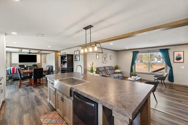 a kitchen with stainless steel appliances granite countertop a stove and a wooden floors