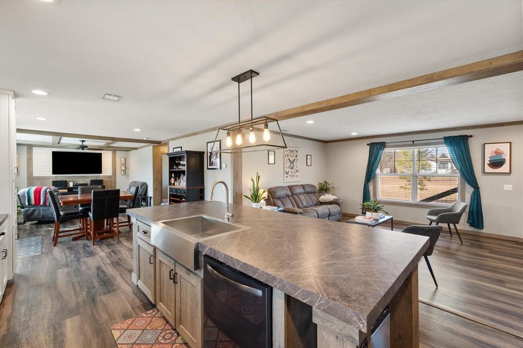 a kitchen with stainless steel appliances granite countertop a stove and a wooden floors