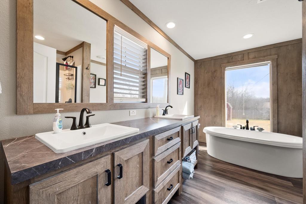 216 Southeast County Road Corsicana, TX 75109 - Photo 21 of 37 a bathroom with a double vanity sink and a mirror