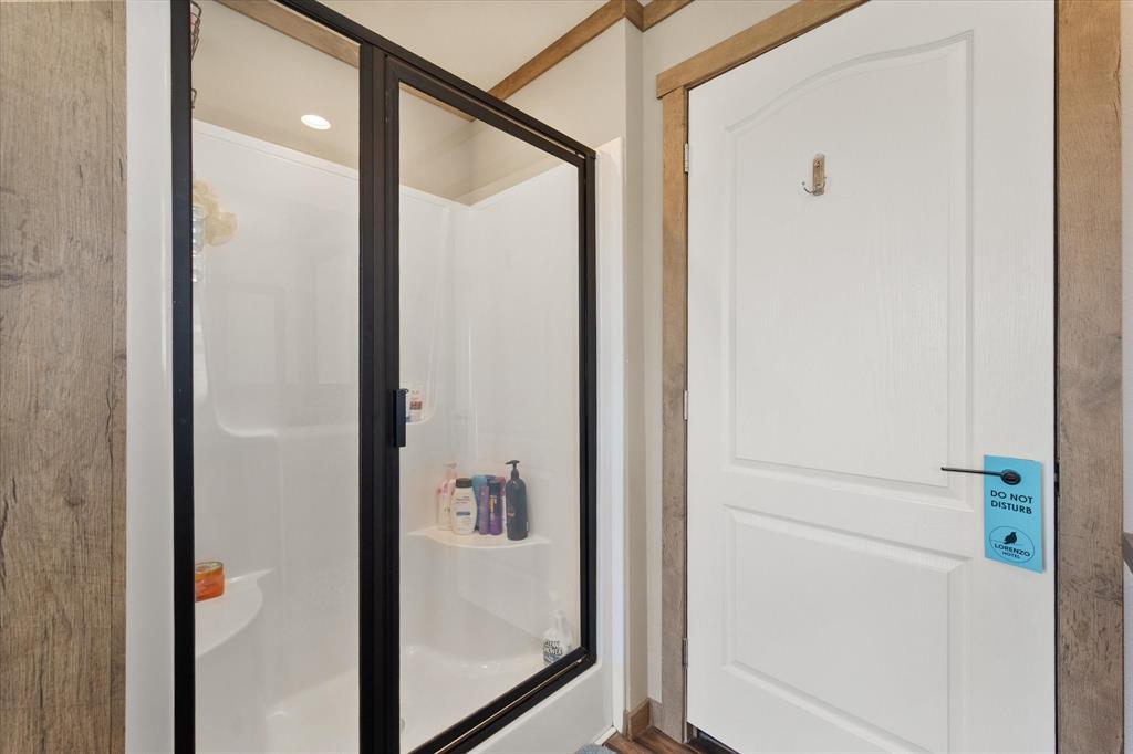 216 Southeast County Road Corsicana, TX 75109 - Photo 23 of 37 a bathroom with a glass shower door